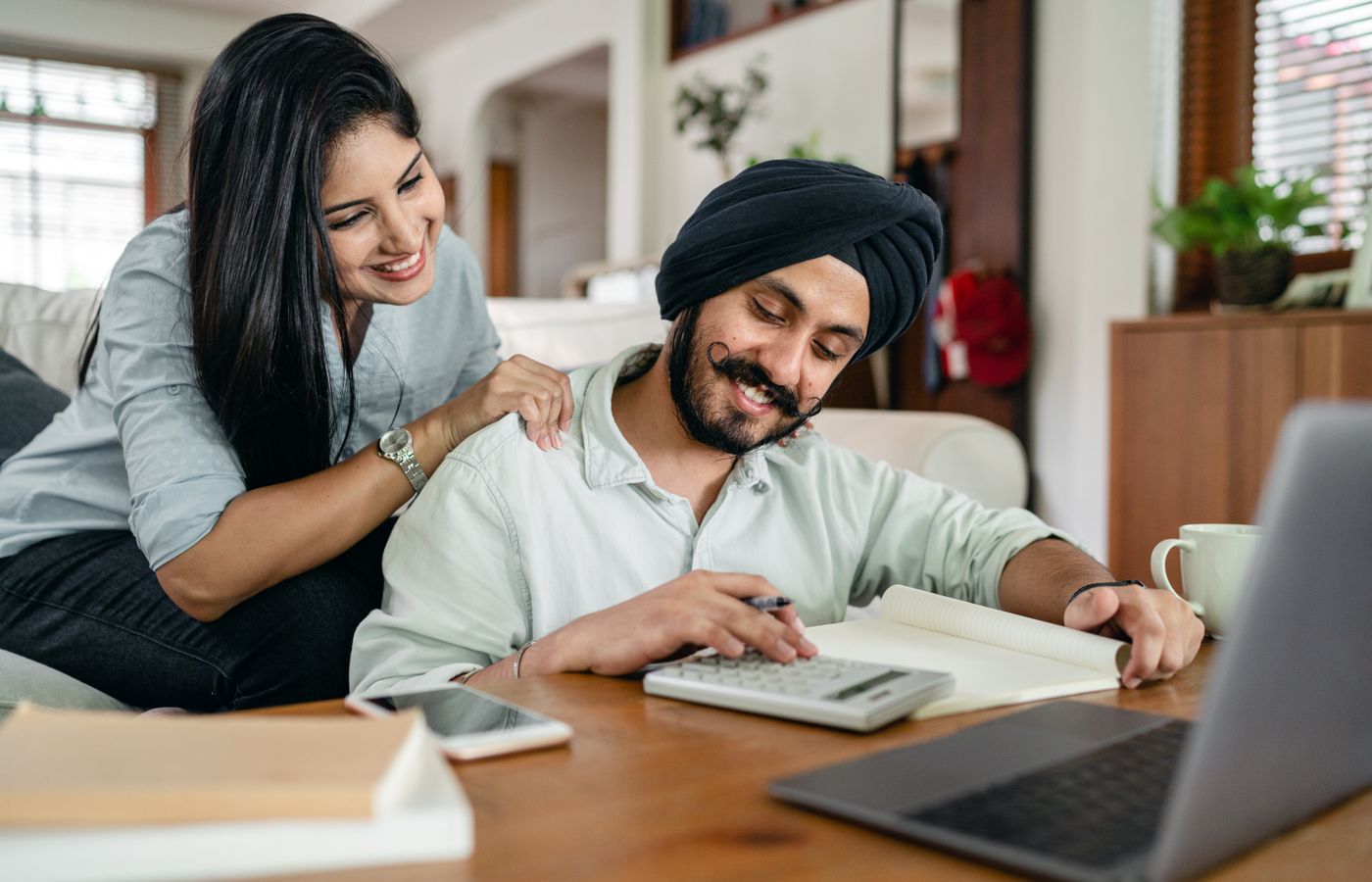 A couple reviewing household paperwork together at home.