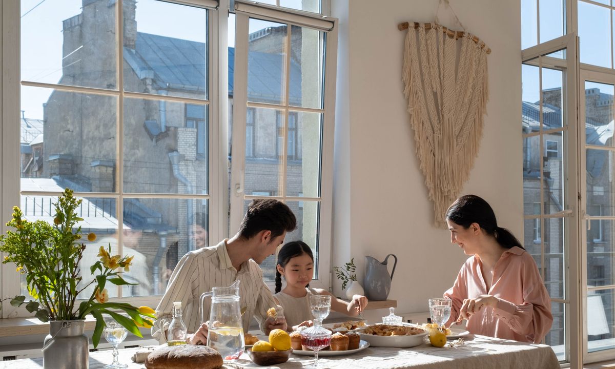 A family sharing a meal in a bright dining room.